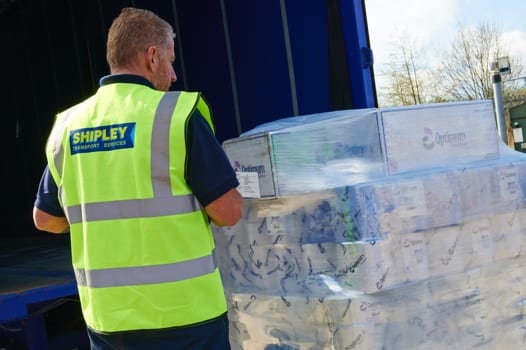 Haulage driver loading pallet on to modern truck